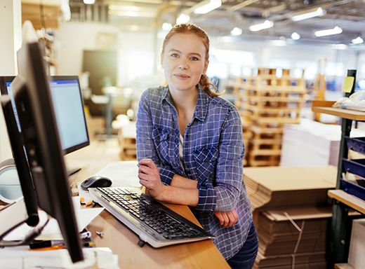 A package designer stands at her desk at BCI