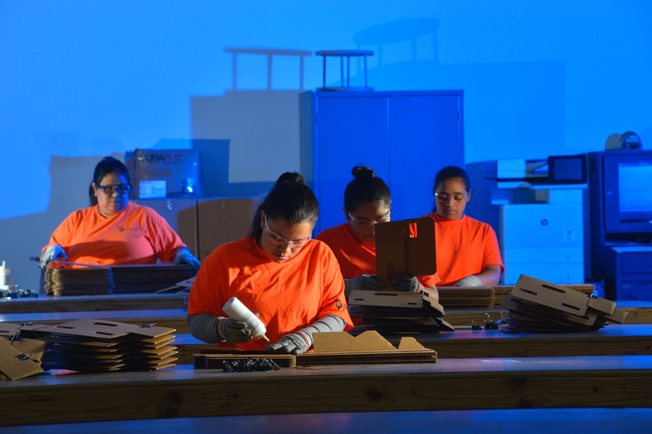 packaging assembly team gluing and assembling corrugated displays