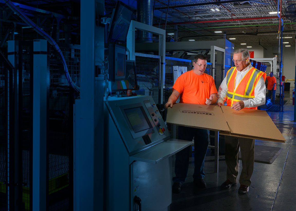Two people discussing corrugated package printing.