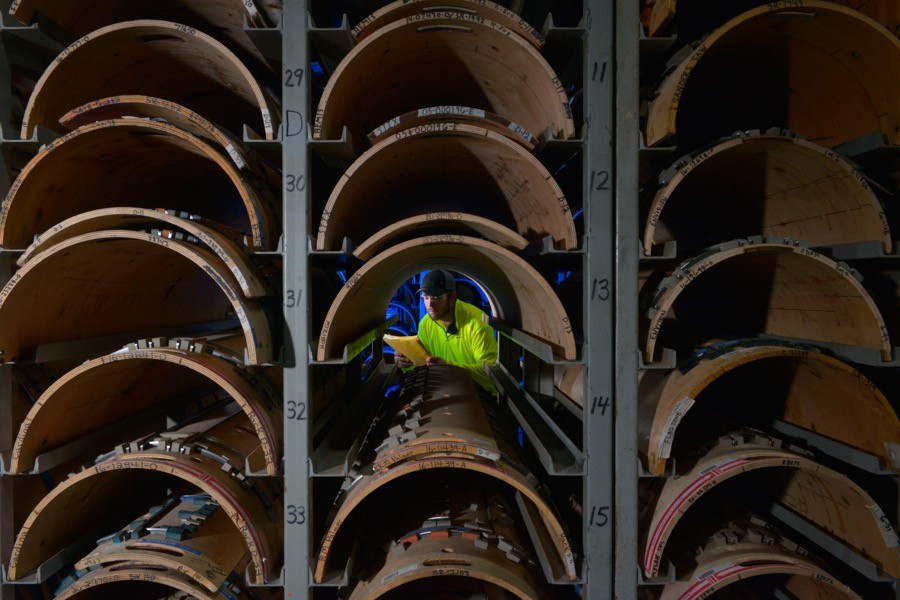 A worker checks the inventory of custom die plates used for right-sized packaging production.